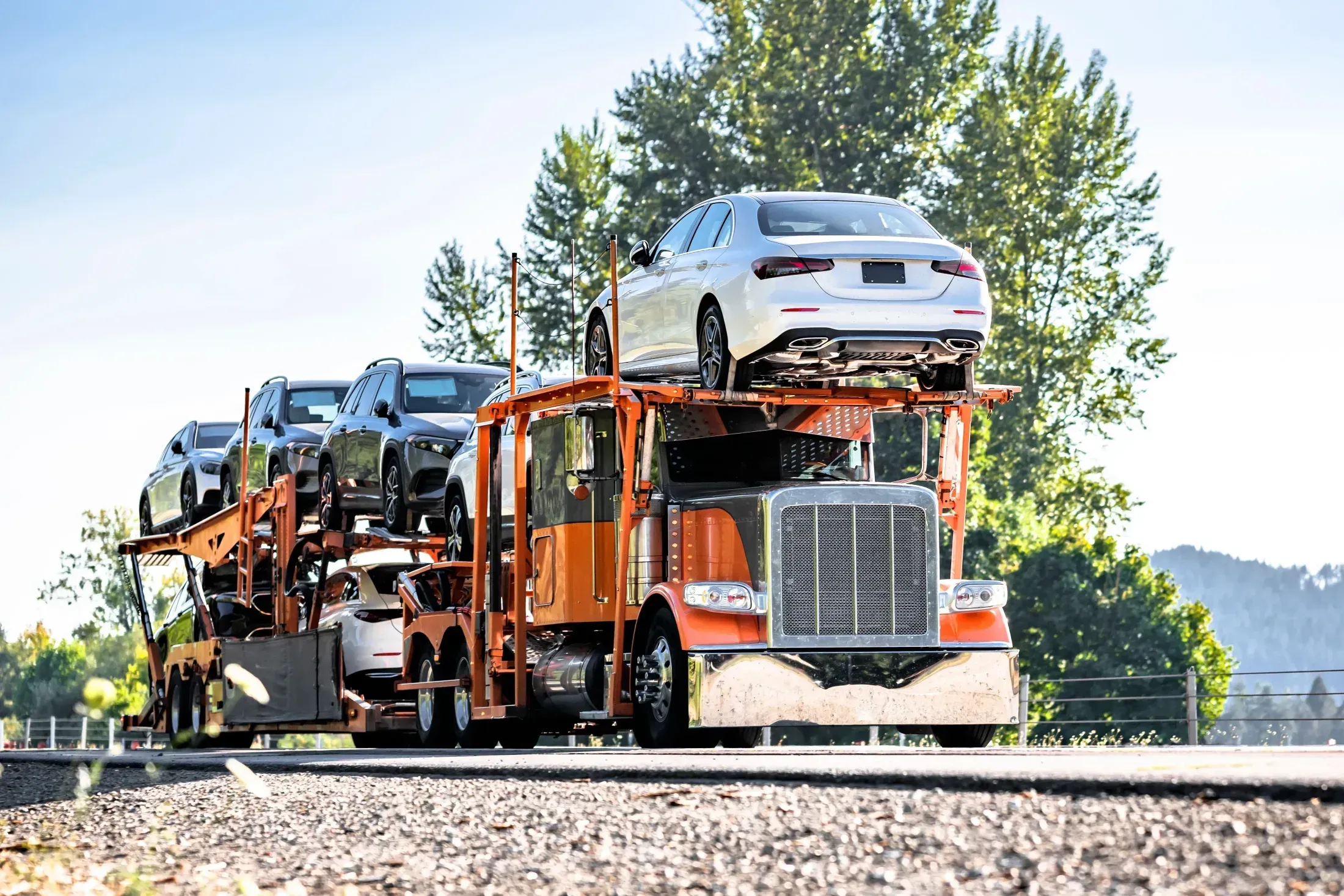 Car shipping cost calculator — modern vehicle on a highway